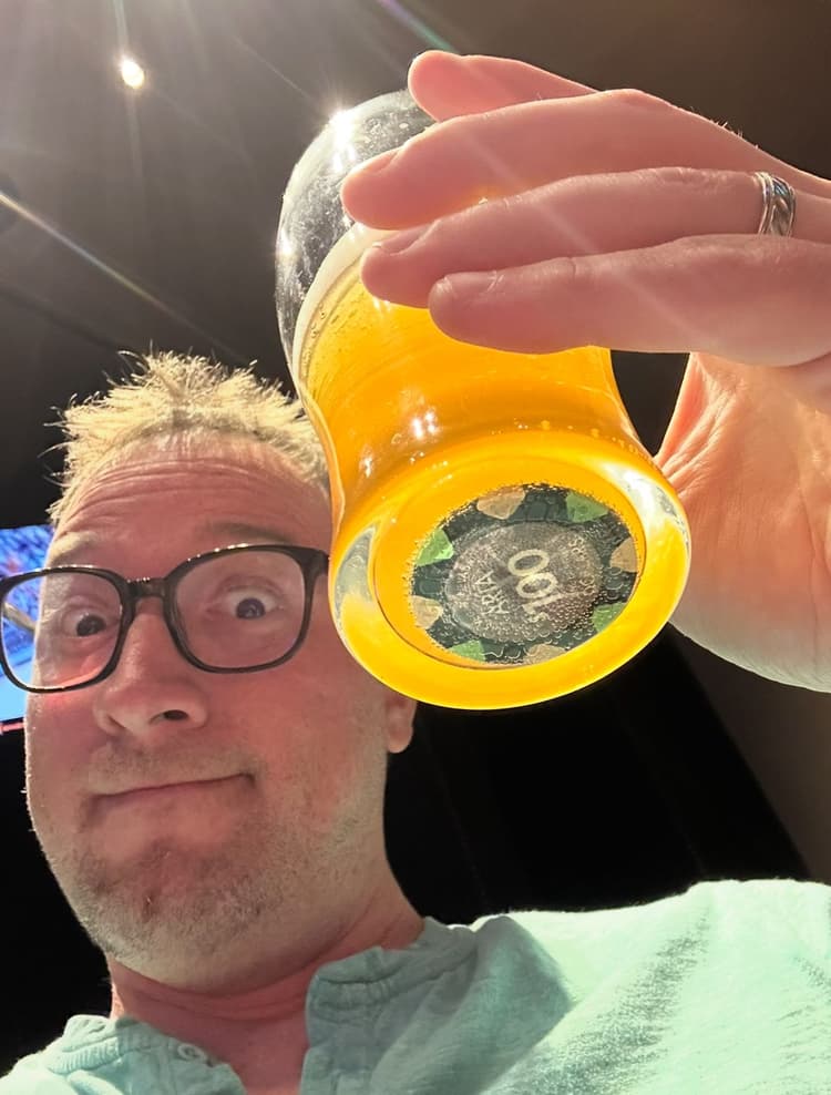 Art Parmann toasting, a $100 Aria chip in the bottom of the glass